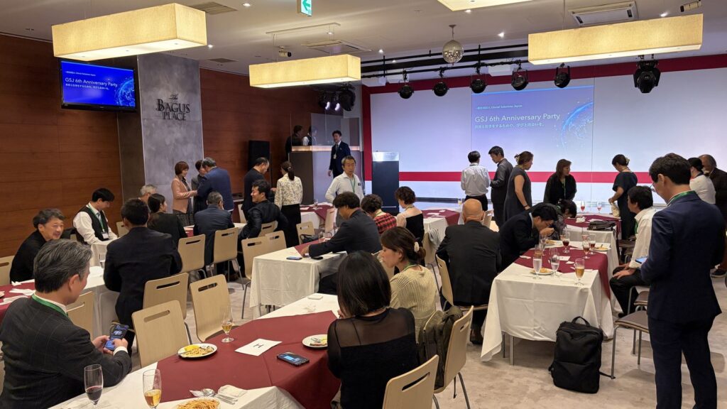 The venue during the social time, with guests standing and talking between the tables